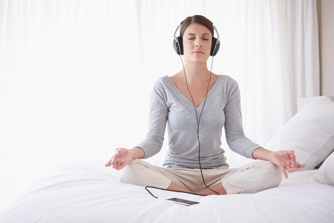 Woman Meditating And Listening To Music