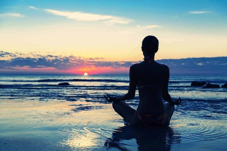 Woman Doing Yoga Near Ocean