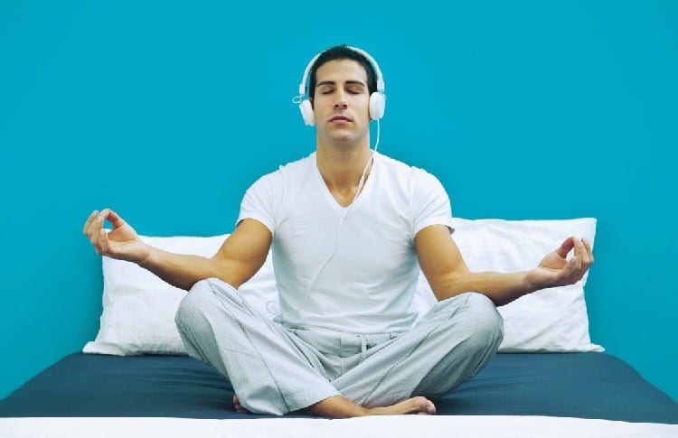 meditation with earphones on bed