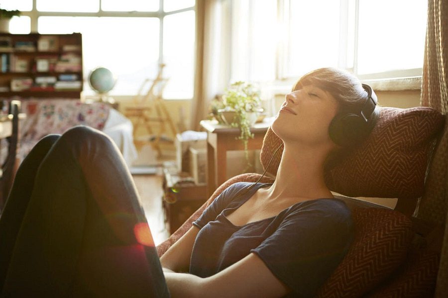 Young woman relaxing with headphones at home