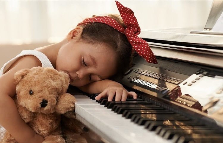 girl falls asleep on piano