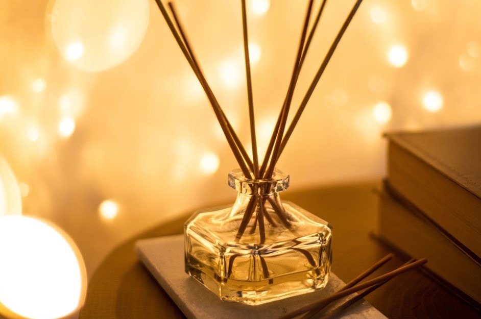 reed diffuser with lights in the background
