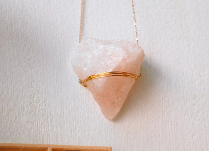 rose quartz crystal pendant on a necklace