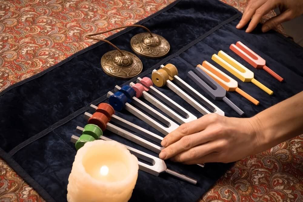 tuning forks for sound healing with hands and bells