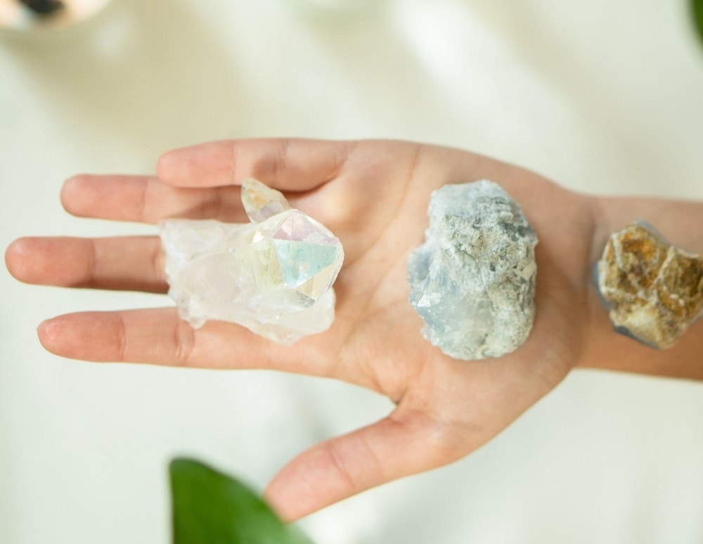 healing stones and crystals held in one hand