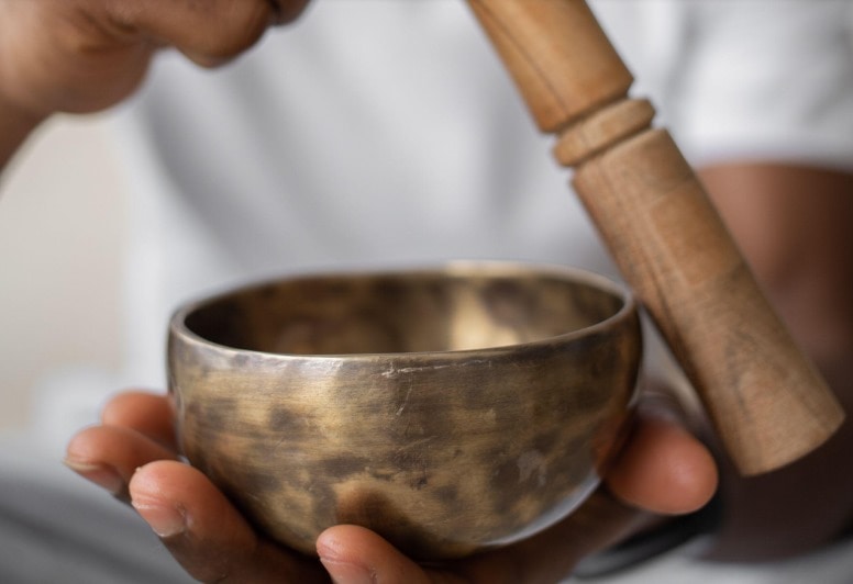 person holding a singing bowl