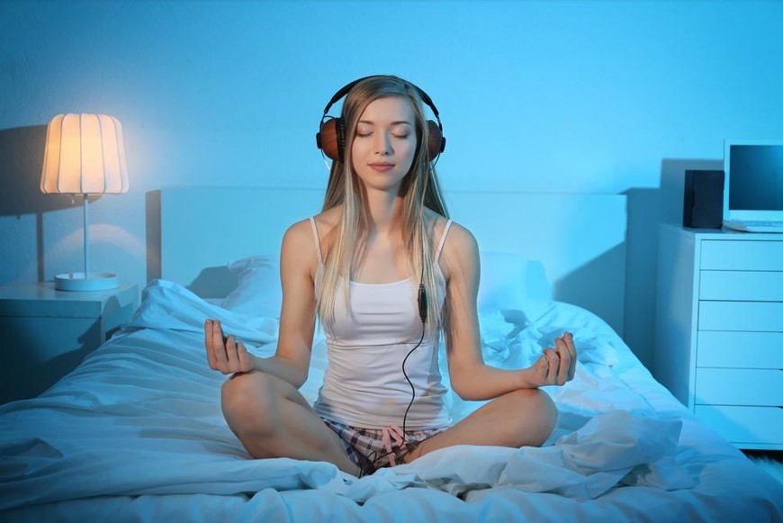 women meditating and listening to the music