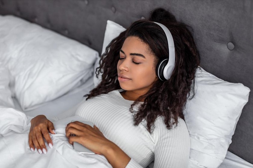 women sleeping with white headphones