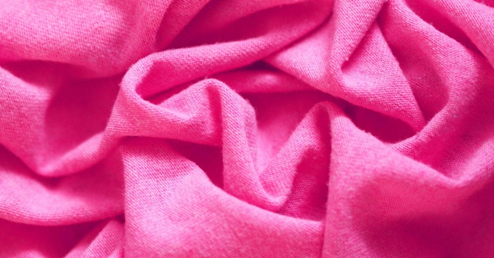 A heavy, rose-colored blanket