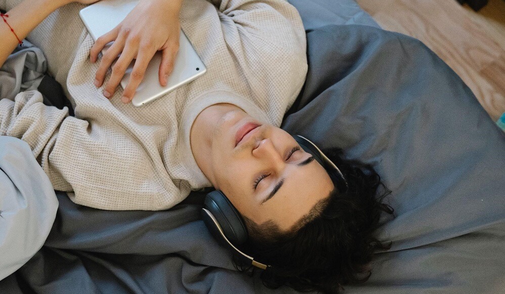 A man sleeping with headphones