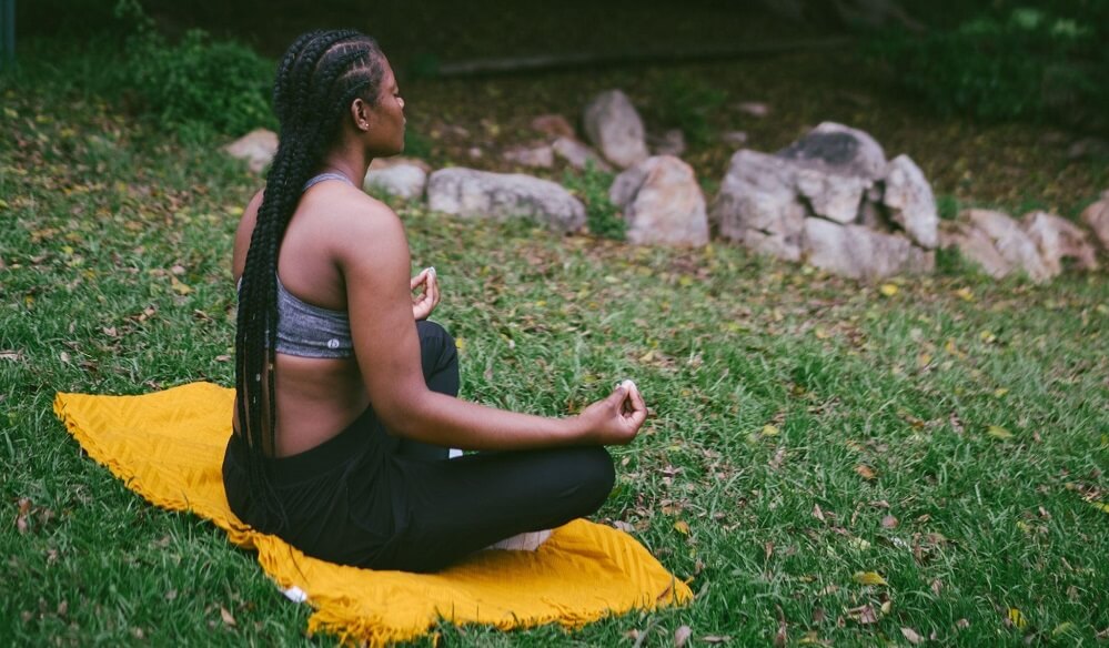 A woman meditating in a park