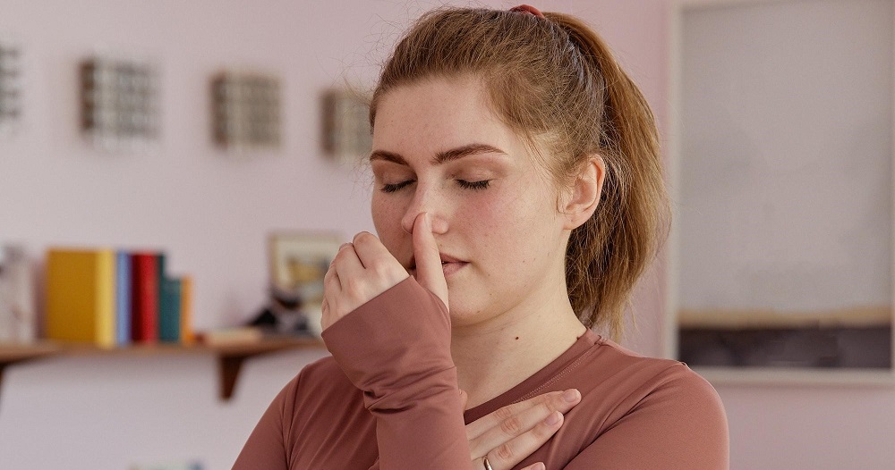 A woman practicing breathing exercises