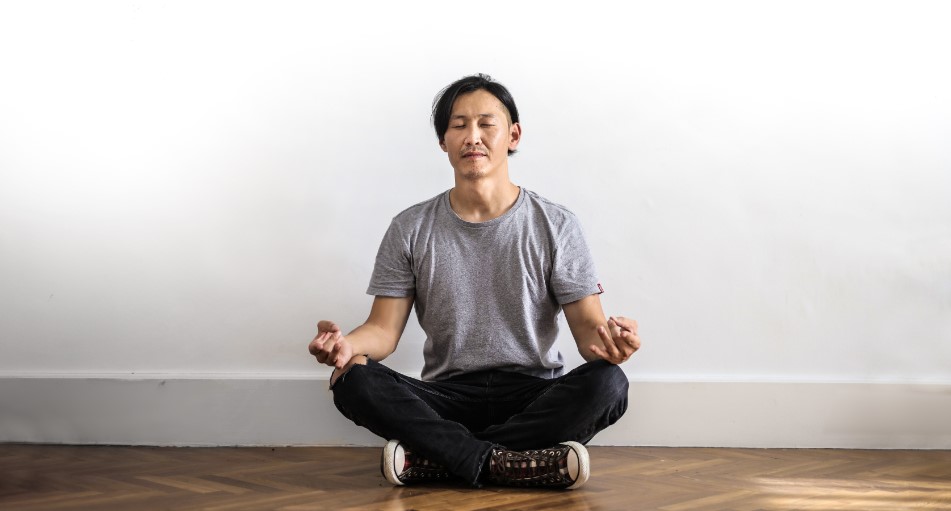 asian man practicing meditation