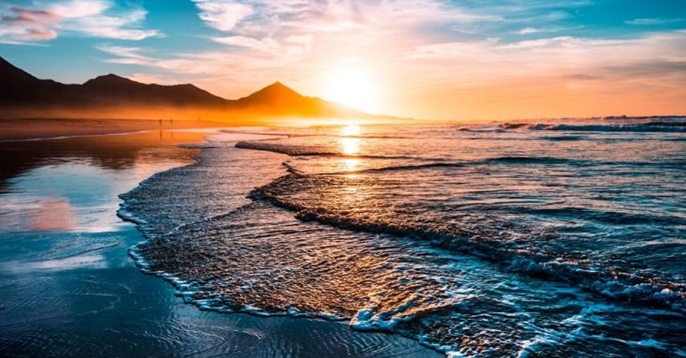 A breathtaking beach sunset with lapping waves ashore