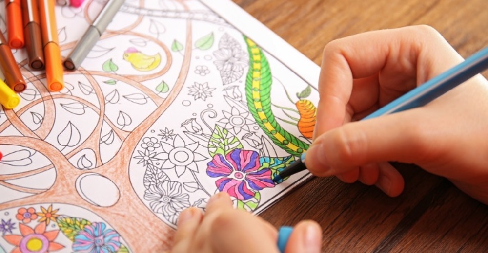 Adult hand coloring flowers