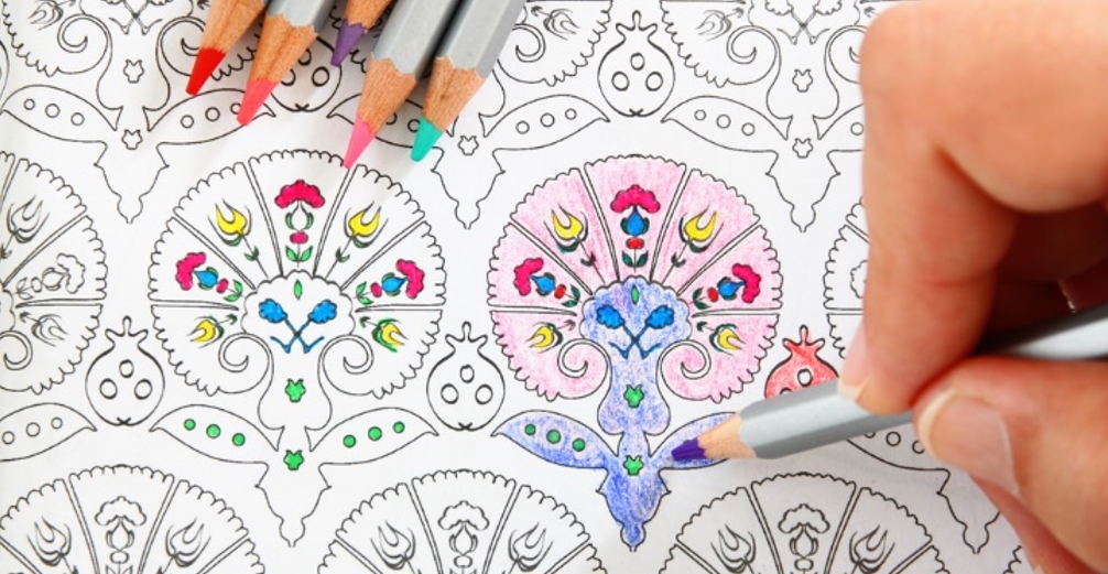 Woman coloring in adult coloring book