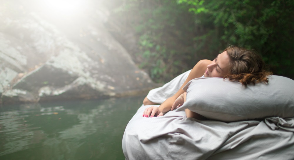 sleeping woman in deep forest lies on airbed