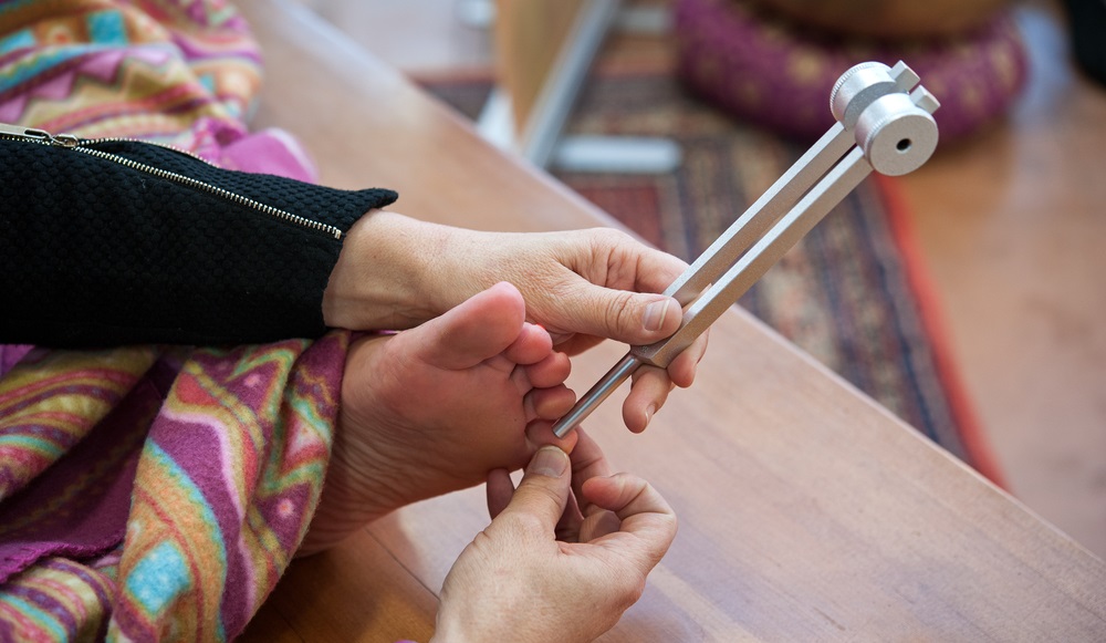 the music therapist takes care of the patient with tuning fork